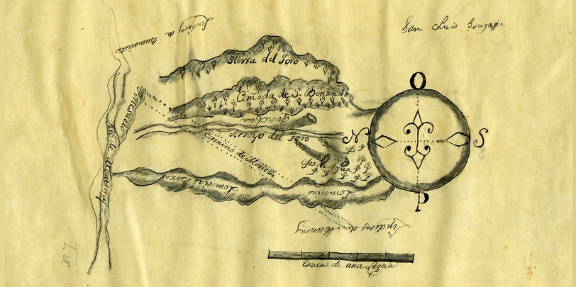 Old, yellowed map with curly lines marking off land grants. Text says" Sierra del Toro, Arroyo del Toro. Other words have faded. Hand drawn compass indicating directions in Spanish.