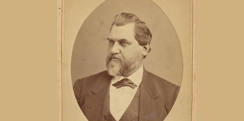 Portrait of Leland Stanford in middle age. Bearded with bow tie and three piece suit.