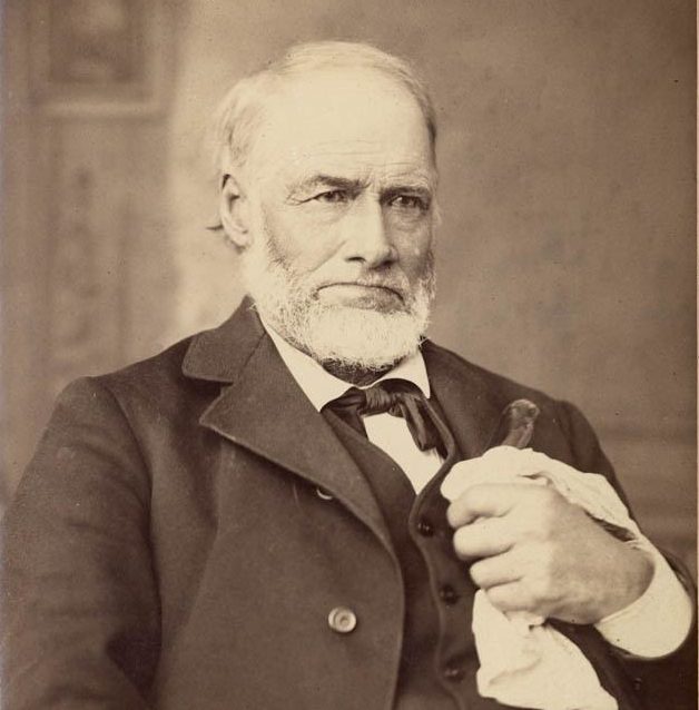 Portrait of Marshall seated, holding a handkerchief and a cane in his left hand.