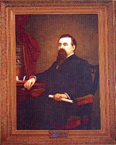 Painting of bearded Governor Pacheco sitting at desk holding a rolled up paper.