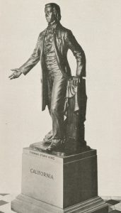 Statue of Thomas Starr King with outstretched hand and other hand resting on a pillar. Wears three piece suit.