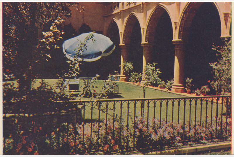 Shows interior garden, table with umbrella.