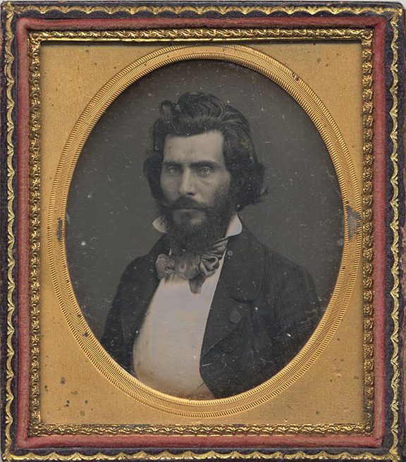 Bust-length portrait of journalist and poet, John Rollin Ridge with longish hair and a beard and mustache; considered the first Native American novelist