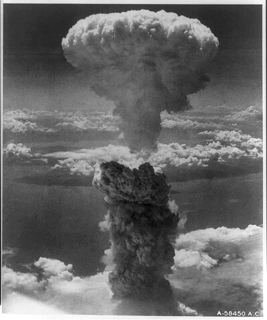 Photograph shows atomic bomb mushroom cloud over Nagasaki.